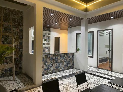 a restaurant with a counter and chairs in a room at A Luc House in Cat Ba