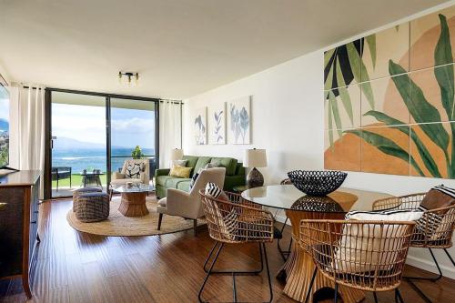 a living room with a table and chairs at Lauloa 106 in Wailuku