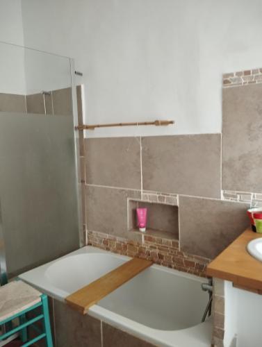 a kitchen with a bath tub in a room at atypical house garden in Saint-Paulet-de-Caisson