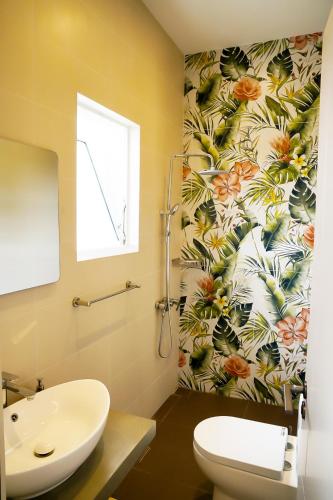 a bathroom with a toilet and a sink at Lotus Luxury Residencies in Negombo
