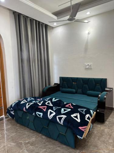 a bedroom with a bed and a couch in a room at shivoham Stays in Mājra