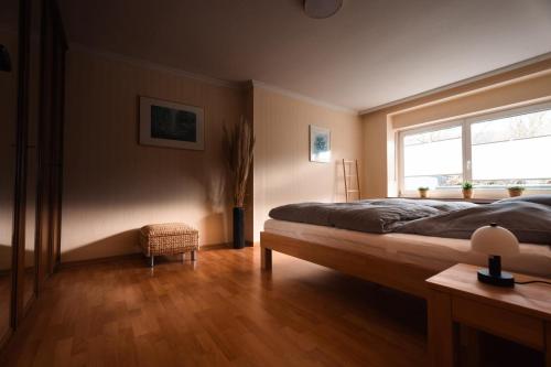 a bedroom with a large bed and a window at Ferienwohnung Haus Mäsch in Wellen