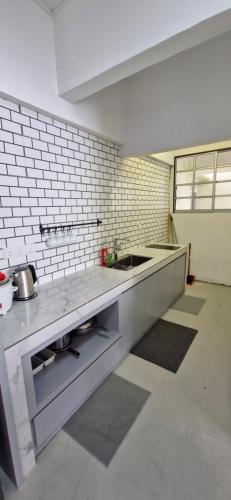 a kitchen with a sink and a counter top at A3-6-1Silverpark LuxMountsin view Lifted unit in Bukit Fraser