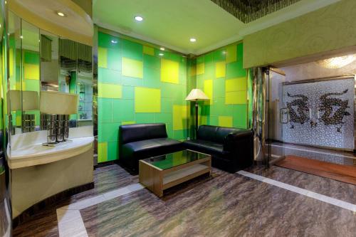 a living room with a couch and a table at RedDoorz Plus near Simpang Tiga Tritayasa Cilegon in Cilegon