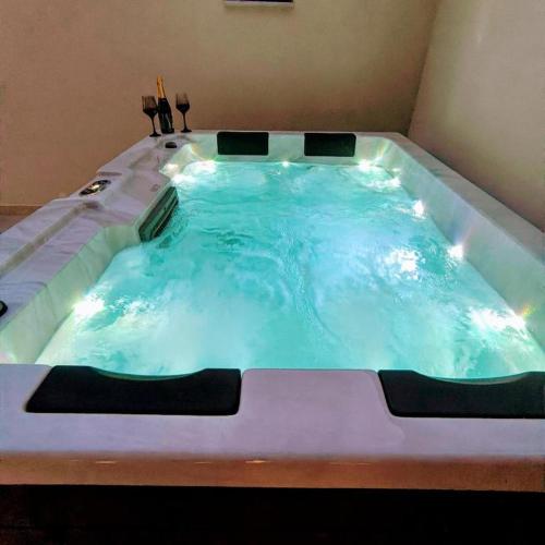 a large bath tub filled with blue water at Malakion Lux Seaside Jacuzzi in Malaki