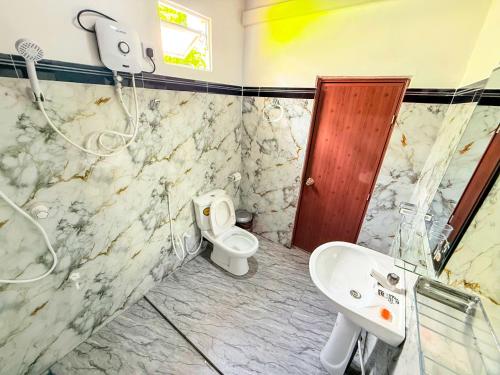 a bathroom with a toilet and a sink at Sigiriya On Rock Villa in Sigiriya