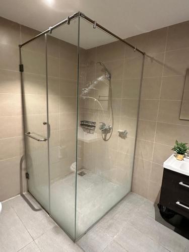 a shower with a glass door in a bathroom at Staye Deluxe 2BHK in Islamabad