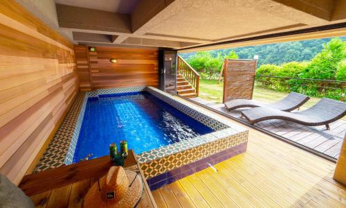 a swimming pool in the middle of a house at Welcome Sunny House in Hongcheon