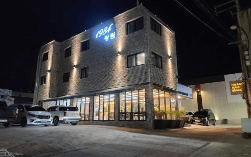 a building with cars parked outside of it at night at Gyeongju Wangrim 1984 in Gyeongju