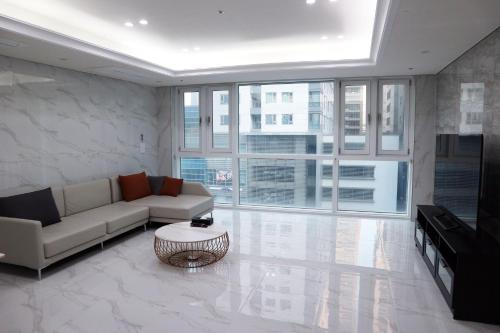a living room with a couch and a table at W Residence Hotel Centum City in Busan