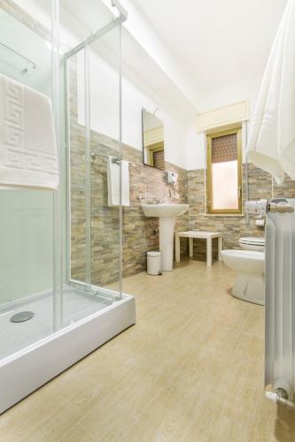 a bathroom with a shower and a toilet and a sink at La Dimora dei sette Arcangeli in Palermo