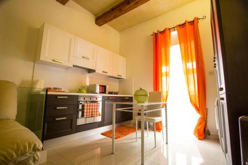 a kitchen with a stove and a table in it at Valletta-Central duplex maisonette in Valletta