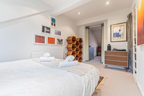 a bedroom with a large white bed and a dresser at Elegant 5-Bed House Free Parking Edgbaston, Birmingham in Birmingham