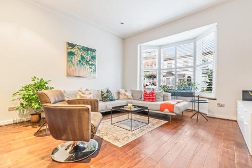 a living room with a couch and a table at Elegant 5-Bed House Free Parking Edgbaston, Birmingham in Birmingham