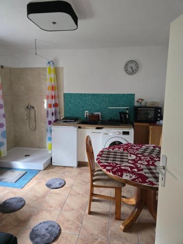 a kitchen with a table and a stove and a table and chairs at Lieber Gruß 38 in Papenburg