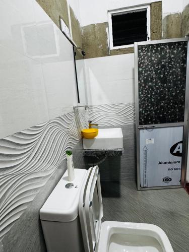 a bathroom with a toilet and a sink at Villa Nevya in Weligama