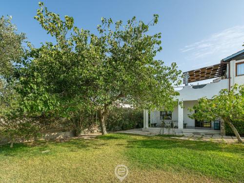 a view of the backyard of a house with trees at Estay - Villa Foxi Serenity - Exclusive holiday in Quartu SantʼElena