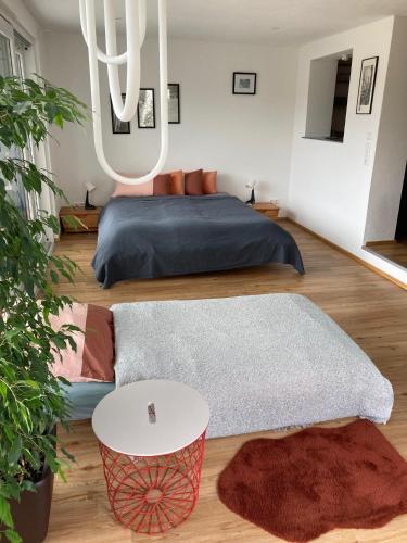 a bedroom with a bed and a table and rug at Außergewöhnliches Apartment in bester Lage in Biberach an der Riß