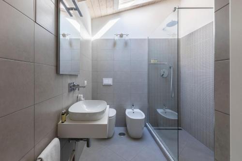 a bathroom with a sink and a toilet and a shower at Palline Chalet by Hili in Rome