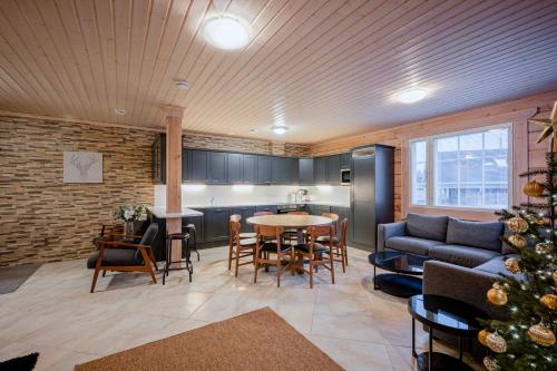 a living room with a christmas tree and a kitchen at Villa Lily ski slopes 300 m, Jacuzzi for extra fee in Himos