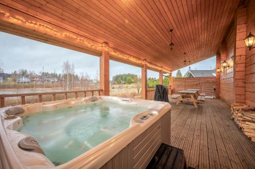 a jacuzzi tub on the deck of a cabin at Villa Lily ski slopes 300 m, Jacuzzi for extra fee in Himos