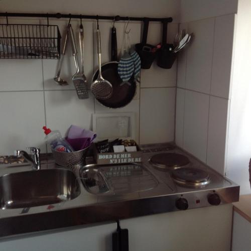 a kitchen counter with a sink and a stove at Zweitheimat in Kalkar