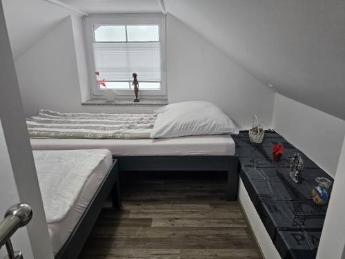 a small bedroom with a bed and a window at Kuća NADA in Donja Voća