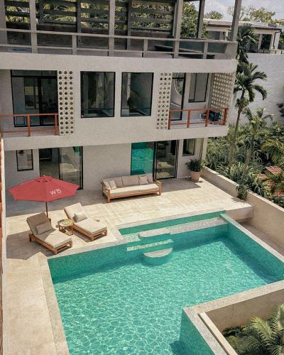 a house with a swimming pool in front of it at W15 Hiriketiya in Dickwella