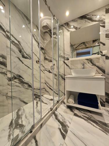 a bathroom with a sink and a shower at Paradise Resort Evia, a member of Radisson Individuals in Eretria