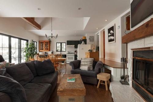 a living room with a couch and a fireplace at Waterfront & Nature - Chalet Lac Clair in Entrelacs