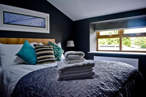 a bedroom with a bed with towels on it at The Ugly Duckling in Telford