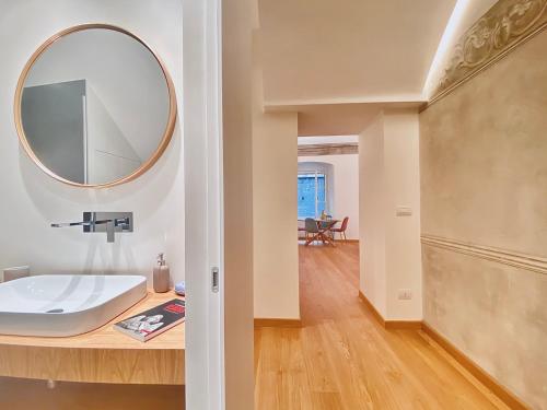 a bathroom with a sink and a mirror on a counter at Amazing San Lorenzo 19 Apt with Private Parking in Genoa