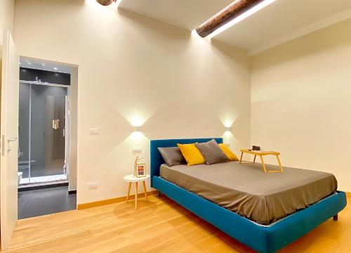 a bedroom with a blue bed in a room at Amazing San Lorenzo 19 Apt with Private Parking in Genoa