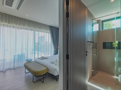 a hotel room with a bed and a shower at Dara Villas - Rawai in Rawai Beach