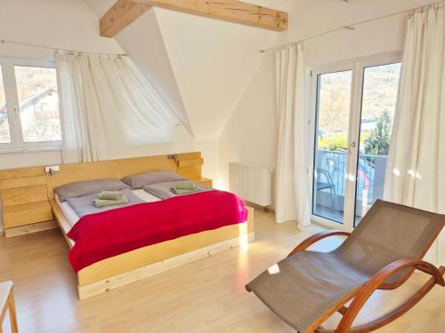 a bedroom with a bed and a chair at Kreischberg Superior with Sauna in Sankt Lorenzen ob Murau
