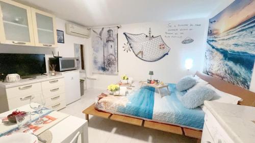 a bedroom with a large bed with blue pillows at Alicetta Apartment by Ca-Sa Check in Chioggia