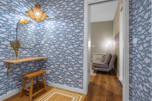 a hallway with a blue patterned wall at SEBASTIAN Apartamentos in Getaria