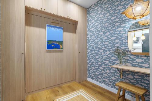 a hallway with a door and a wall covered in wallpaper at SEBASTIAN Apartamentos in Getaria