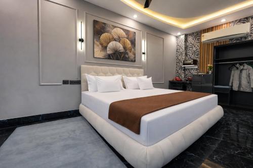 a bedroom with a large white bed and a fireplace at The Boutique Studio Near Green Park Delhi- By ACESTAYZ in New Delhi