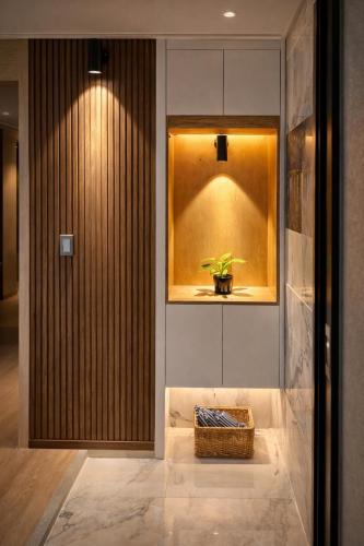 a hallway with a plant in a window and a basket at premium ocean view in HAEHUNDAE BONA TOGETHER in Busan