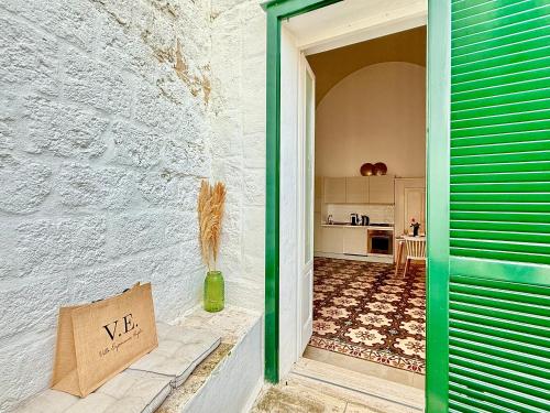 a door to a kitchen with a sign that says we at Residenza Garibaldi in Monopoli