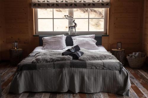 a bed in a room with a large window at Lammasmäe Puhkekeskus in Linnuse