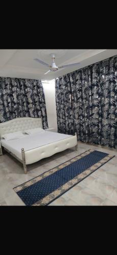 a bed in a room with a ceiling fan at Zahra Suites in Elephant Island