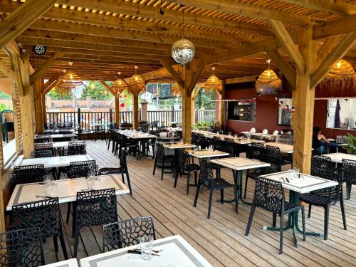 an empty restaurant with tables and chairs in the middle at Camping Domaine de Senaud in Albon