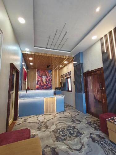 a room with a large room with blue walls at Hotel Padma Residency in Datia