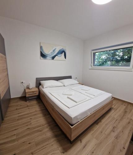 a bedroom with a large bed and a window at Villa Karizma - sea view, swimming pool, hot tub, Brijuni, Fazana, Peroj in Peroj