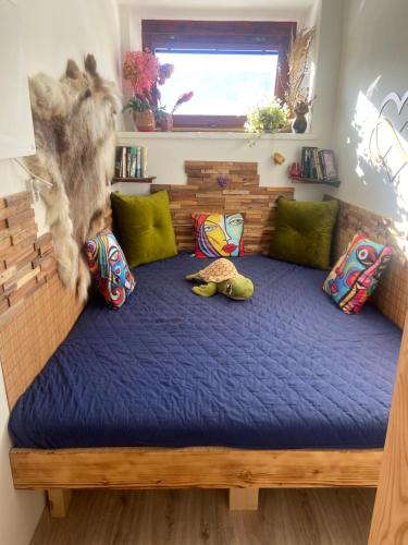 a bed in a room with some pillows on it at Luxusný apartmán u Loly in Polomka