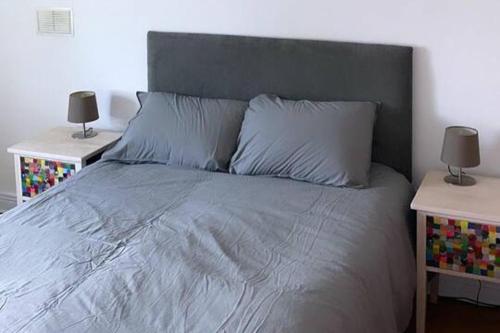 a bedroom with a bed with two nightstands and two lamps at 3Br Apartment - Sleeps 7 - Free Parking - Athy in Athy