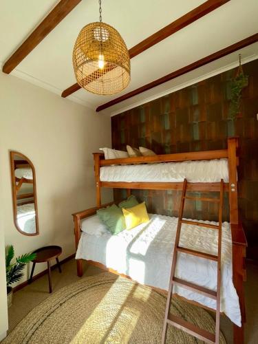 a bedroom with a bunk bed and a ladder at Serenity in Fish Hoek