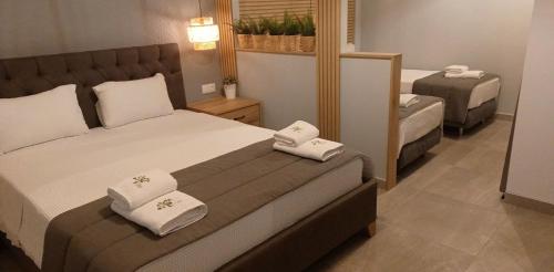 a bedroom with a bed with two towels on it at Seaside Studios in Paralia Dionysiou